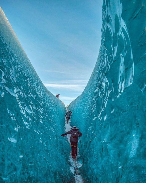 people hiking on glacier